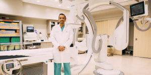 Dr. Chandrasekaran stands in the Interventional Radiology suite.